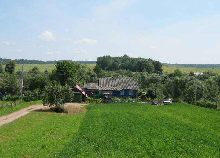 За дамамі бачна старажытнае гарадзішча, заросшае хмызняком. У ХVI стагоддзі тут быў і маёнтак Ясінскіх...